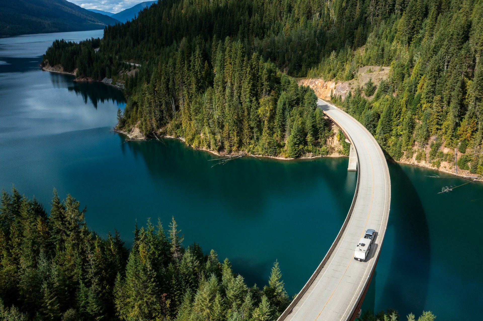 Aerial view of an RV crossing a bridge over a lake.