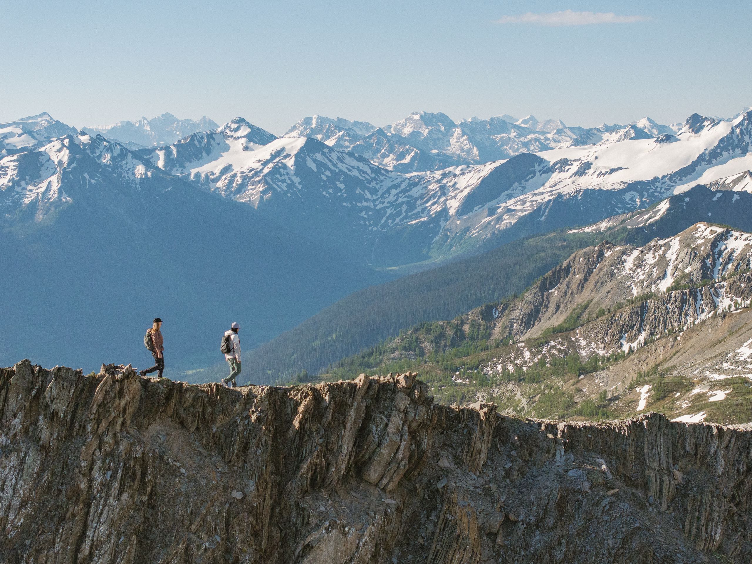 Two friends hiking alongside the glaciers and mountains of Bugaboo Provincial Park during a heli-hiking trip with CMH Bugaboos.