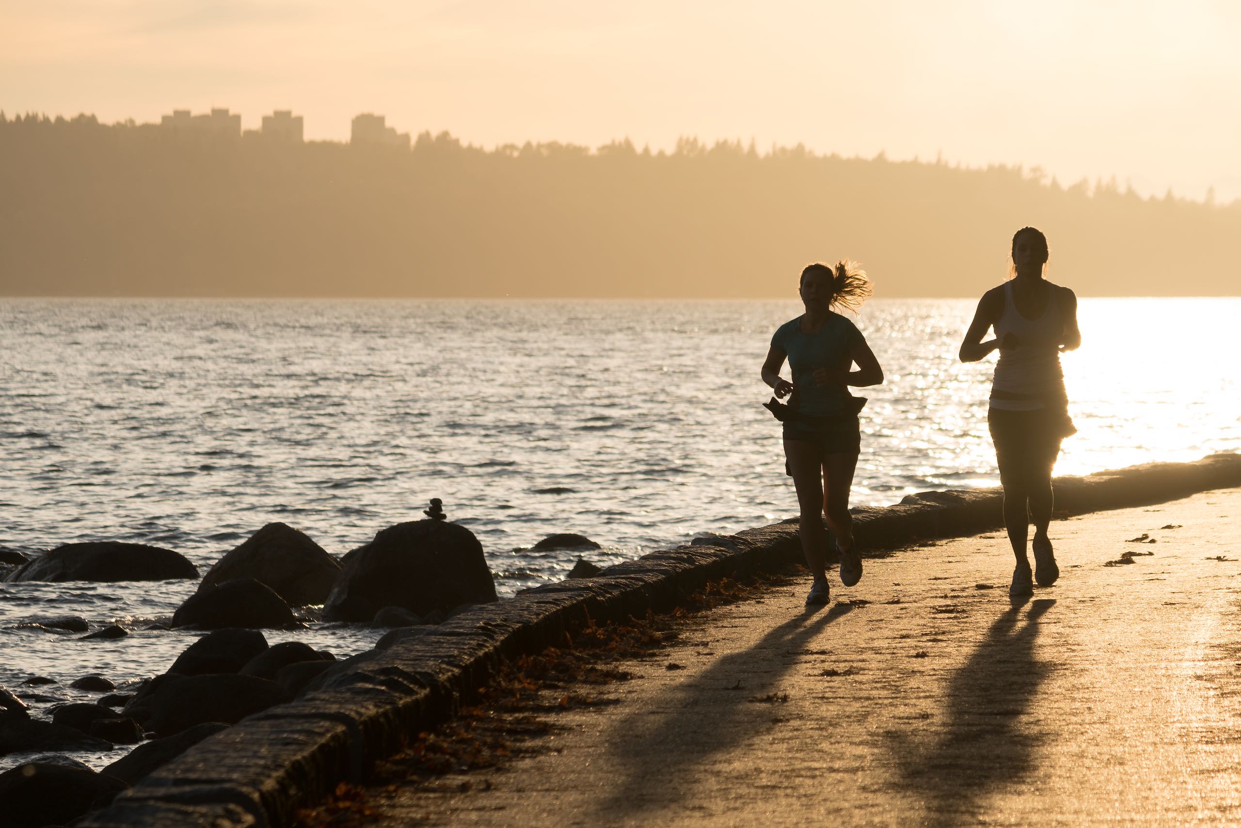 Jogging along the Stanley Park Seawall at sunset