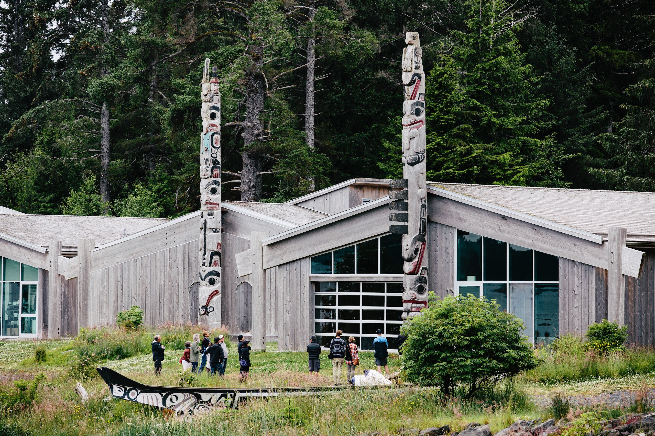 Haida Heritage Centre with people standing in the yard