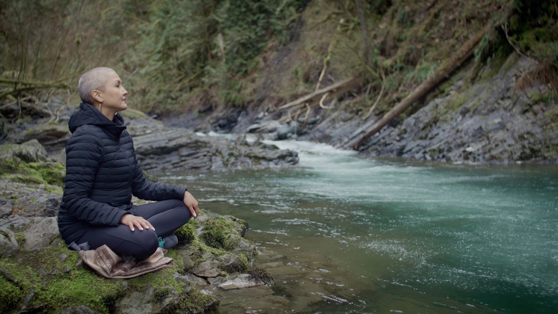 A woman standing next to a stream in BC