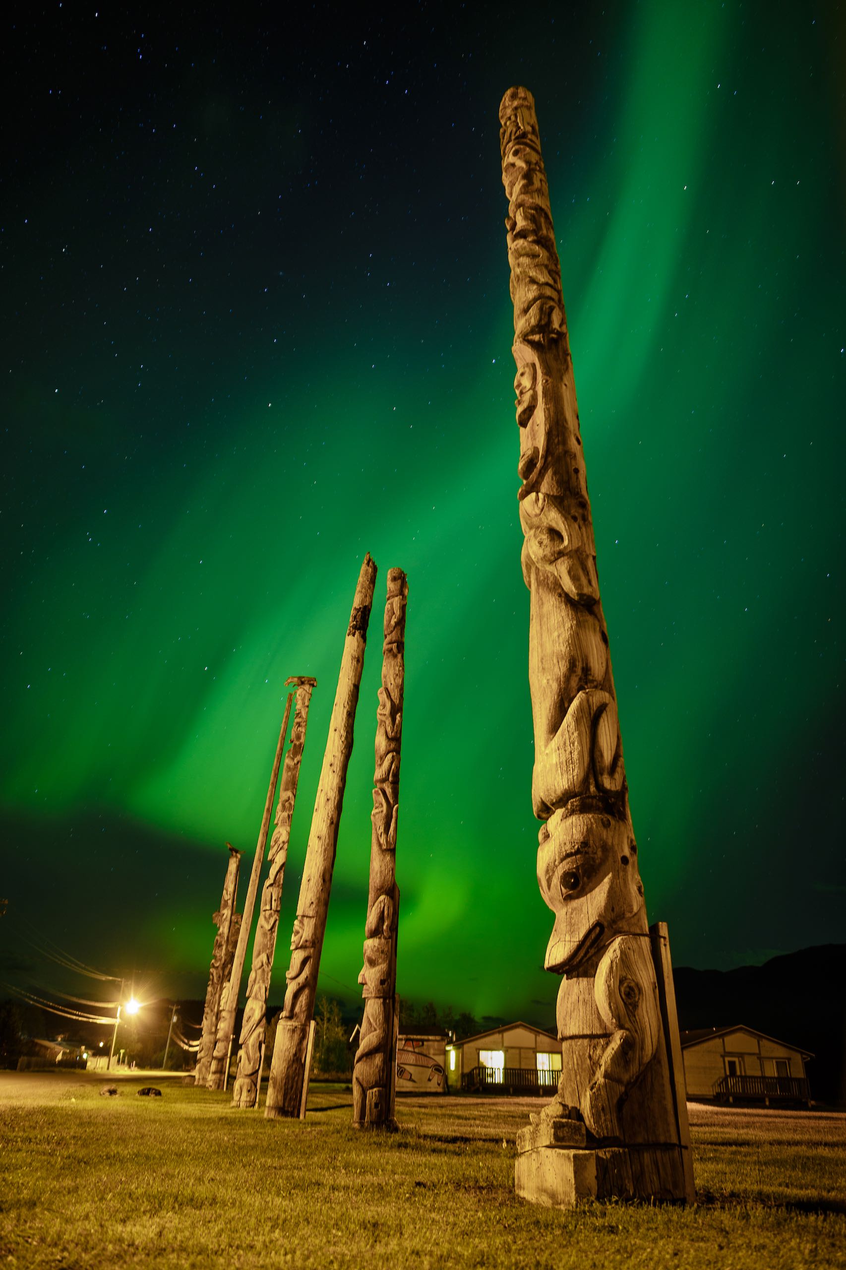 Gitwangak totem poles with Aurora Borealis